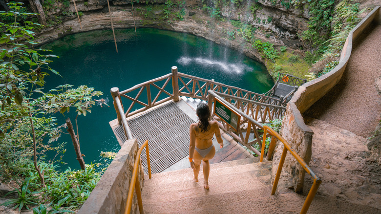 Woman walking into cenote