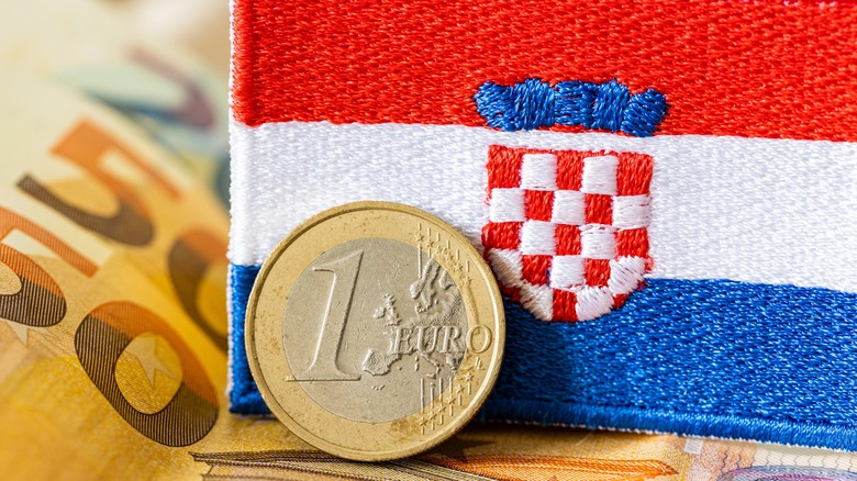 euro coin and croatian flag