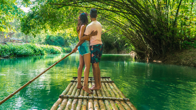 couple on bamboo river raft