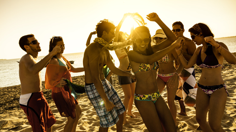 Young people dancing beach spring break