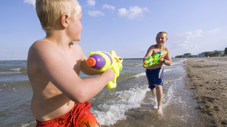 boys playing with water guns