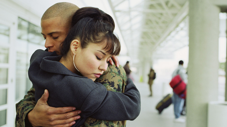 Couple hugs at airport