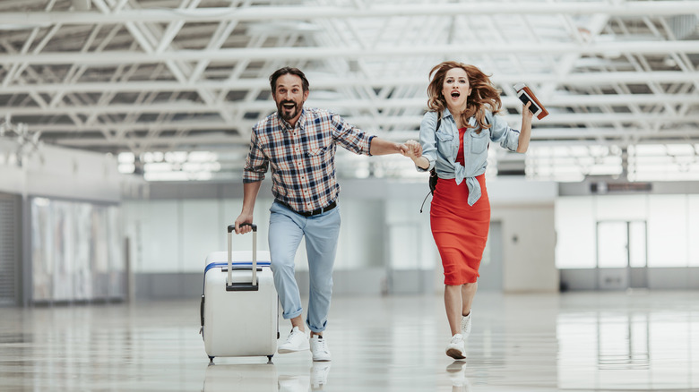 couple running in airport