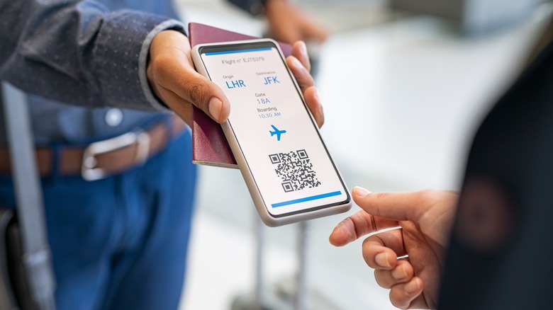 holding digital boarding pass