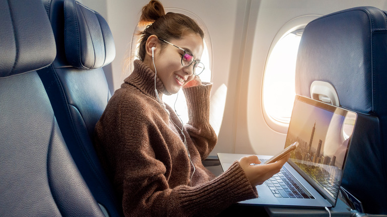 Woman with laptop on plane