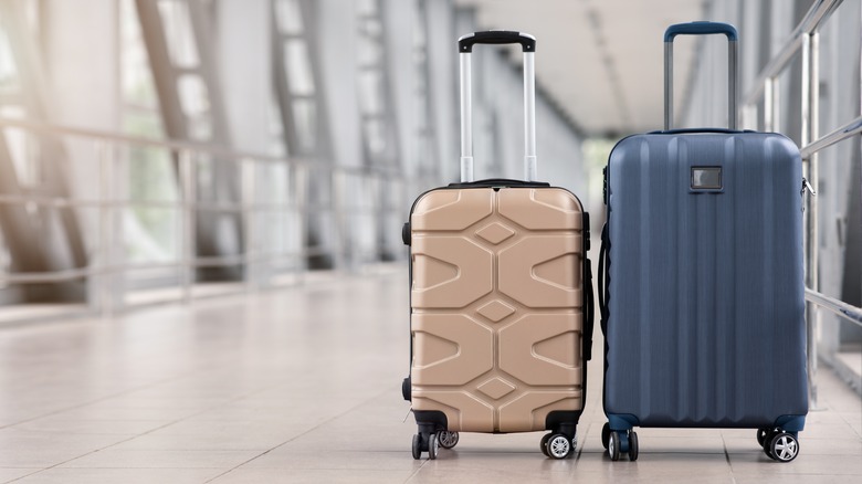 suitcases in empty airport hallway