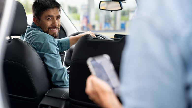 Rideshare driver speaking to passenger