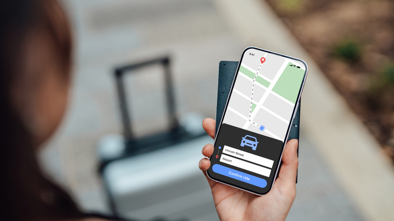 Traveler checking rideshare app