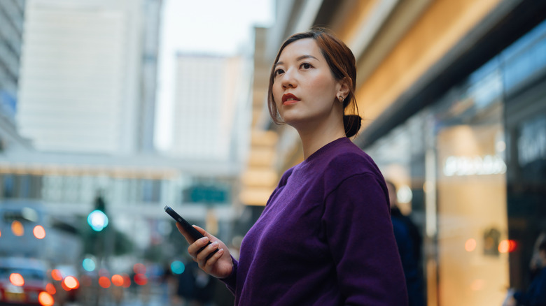 Young woman holding smartphone