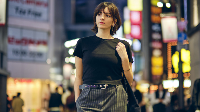 Woman walks down Tokyo street at night