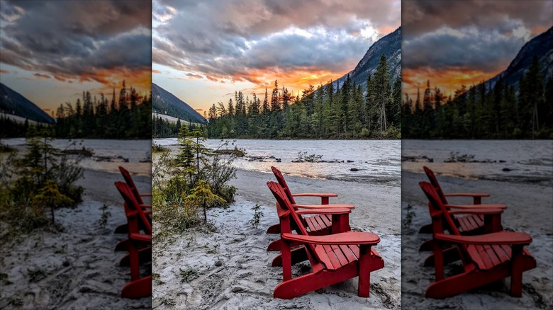 Red chairs by glacial lake in Canada