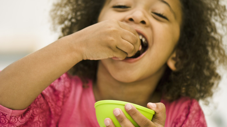 child eating a snack