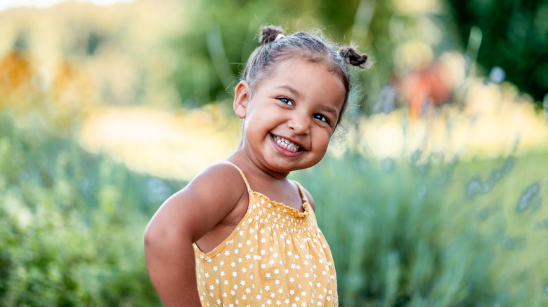 child smiling outside