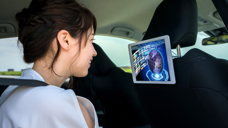 tablet mounted on back of car seat