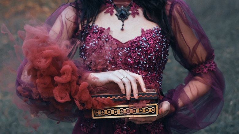 woman holding small spectral casket