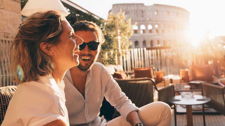 A couple laughing in a cafe in Rome, Italy