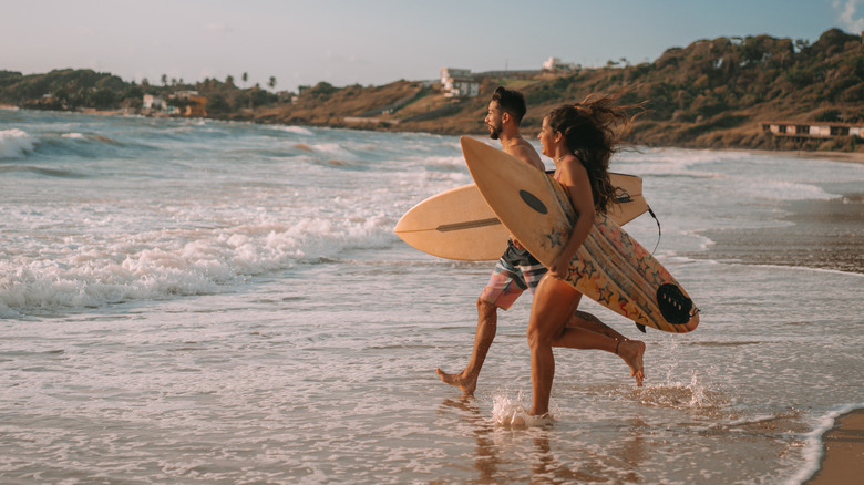 A young couple surfing