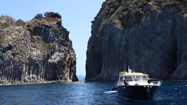 Boat sailing through Palmarola rock formations