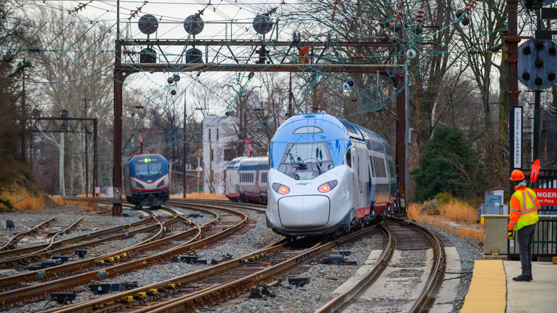 Amtrak train oncoming down railroad tracks