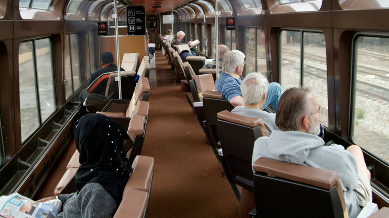 Passengers seated inside Amtrak train looking out windows