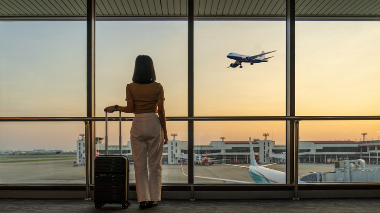 woman watching plane