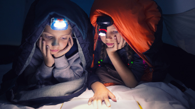Two kids wearing headlamps 