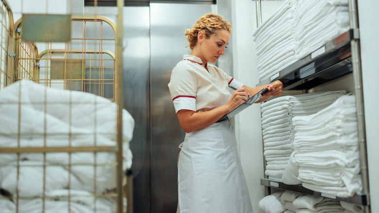 Hotel maid checking towels