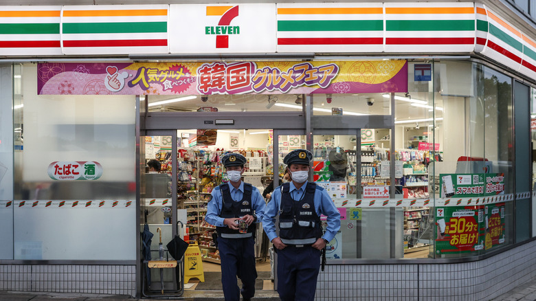 Police walk out of a 7eleven store in Japan