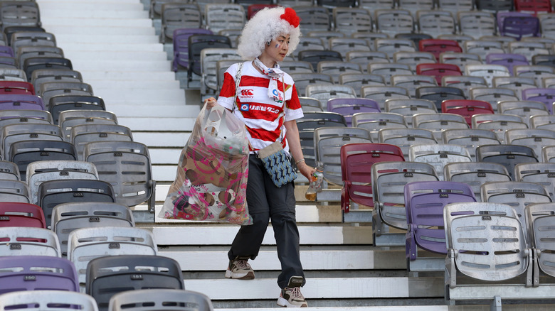 A Japanese fan cleans the stadium after World Cup match