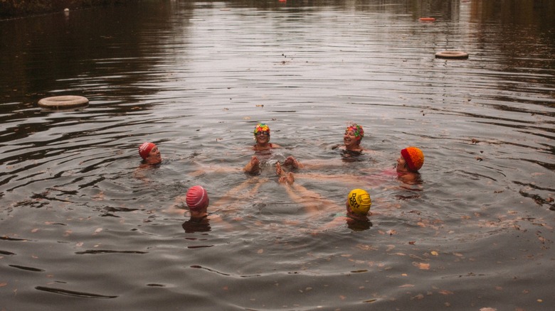 people swimming in hampstead heath pond