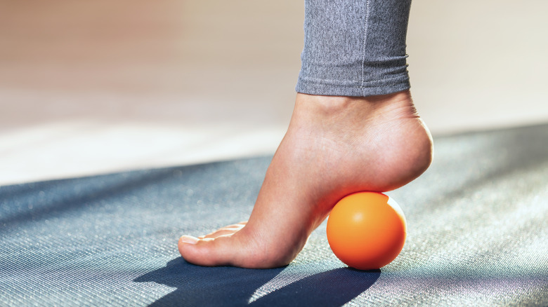Foot on orange ball