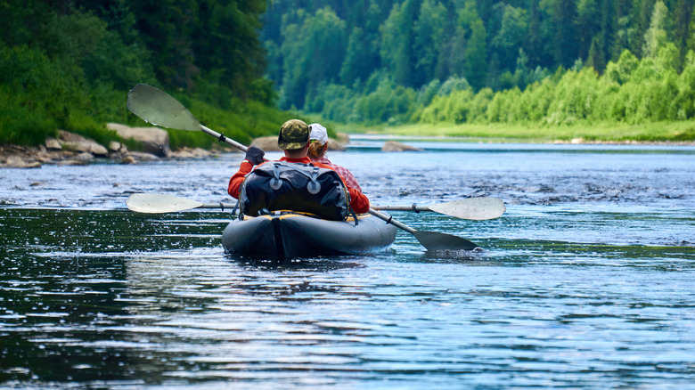 A couple boating on the river.