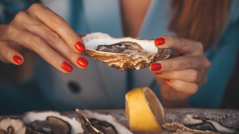 woman holding oyster