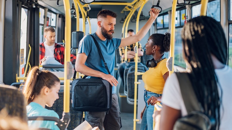 passengers standing on bus