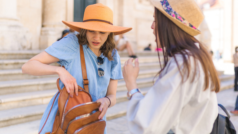 stressed tourists with open backpack