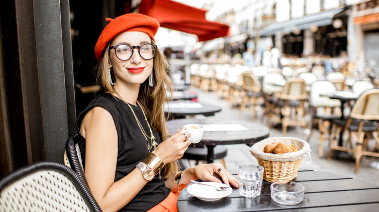 woman having coffee and croissant