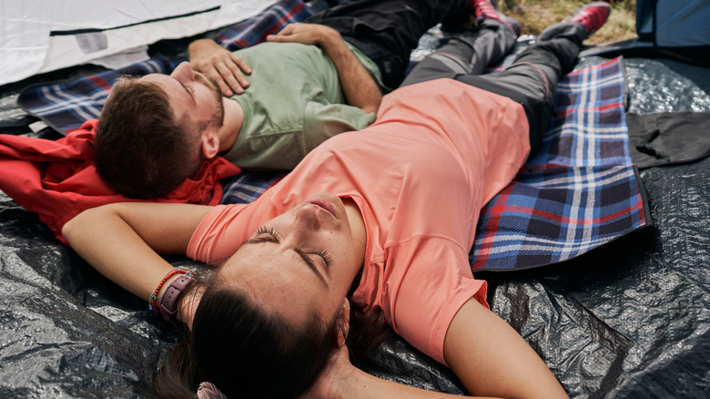 couple relaxing in their tent