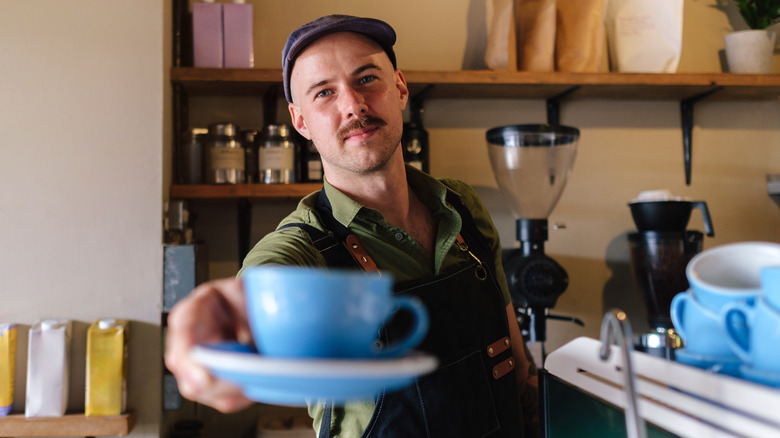 Barista serving drink