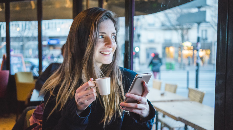 Woman with espresso in café