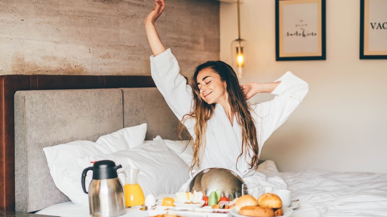 Smiling woman enjoying room service