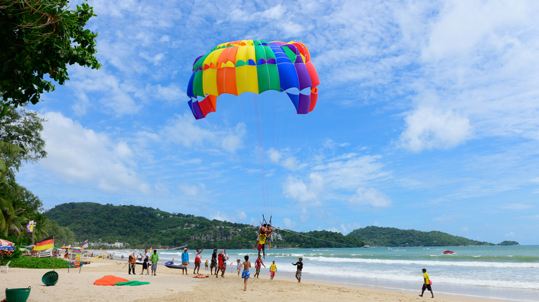 A parasail takes off at a beach in Thailand