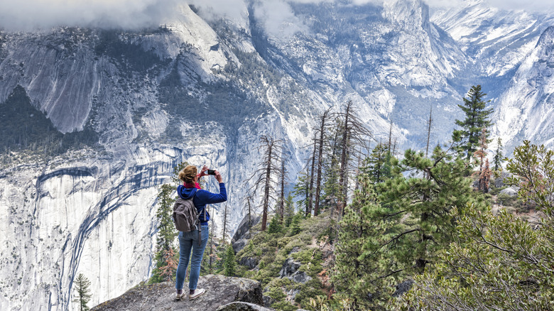 person taking photo of mountains