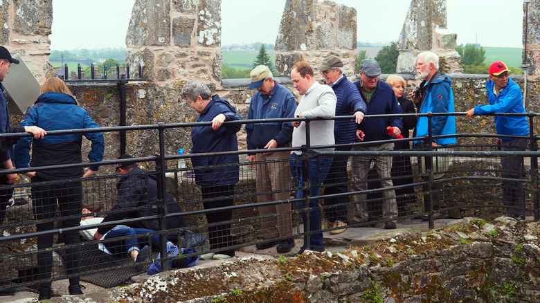 tourists along a castle wall