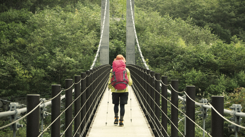 Woman crossing suspension bridge on Mt. Hakusan