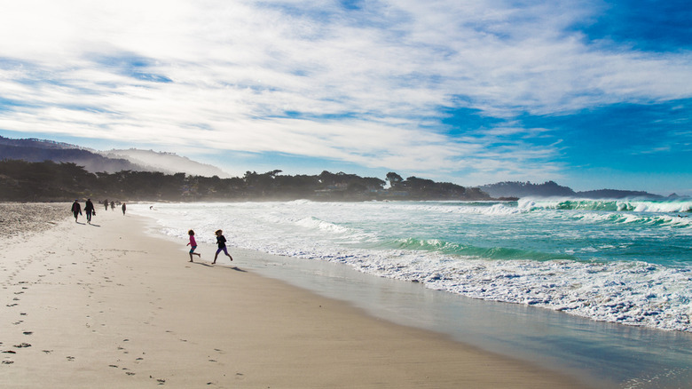 people walking along Carmel Beach