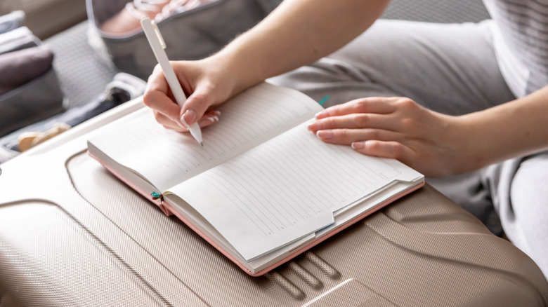 woman creating an organized packing list 