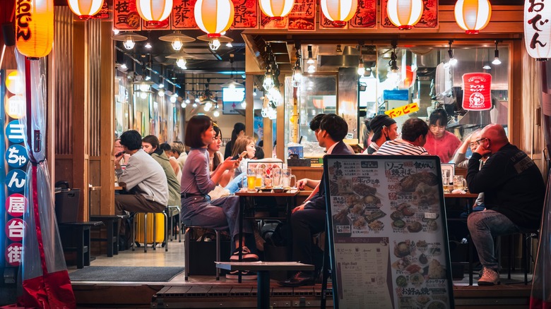 People eating outside Japanese restaurant