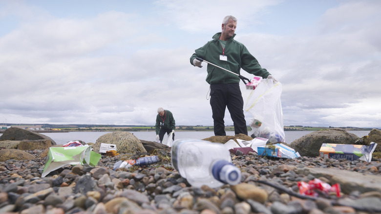 Workers remove litter from a Scottish shore