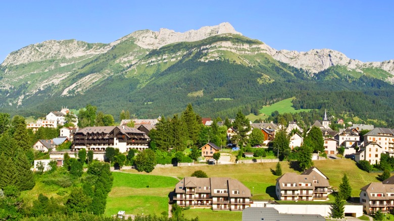 A quaint village among pine trees in the rugged mountains of France.