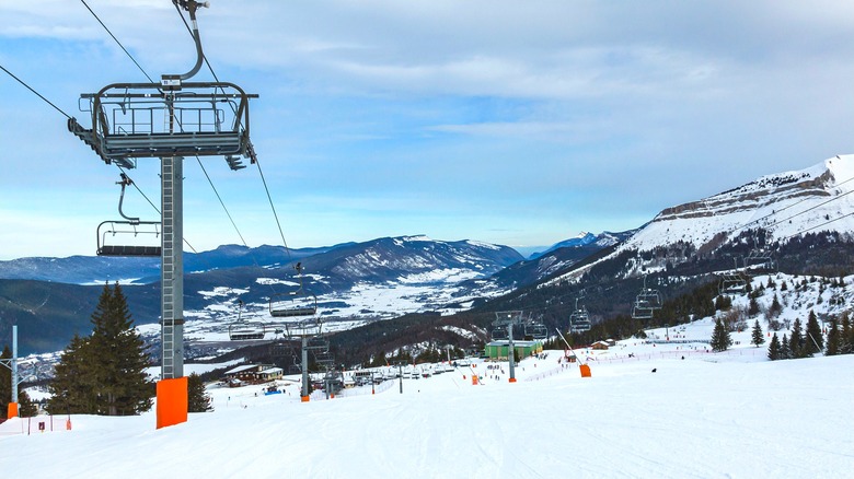 A chair lift on a snowy slope.